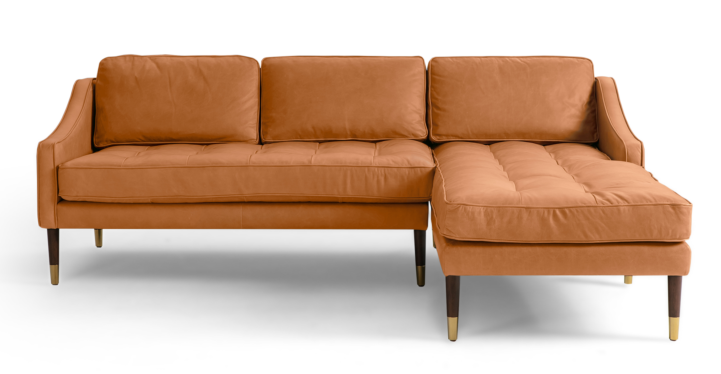 Brando is a modern sectional in light brown leather. The chaise of the sectional, when you are facing the sectional, is on the right and the sofa portion is on the left. Walnut stained legs with gold tips toward the floor. The sofa fully upholstered and has swooping arms that taper from the back, down to the front. Both back and seat cushions are removable. The back cushion is smooth, the seat cushion is tufted. (facing front)