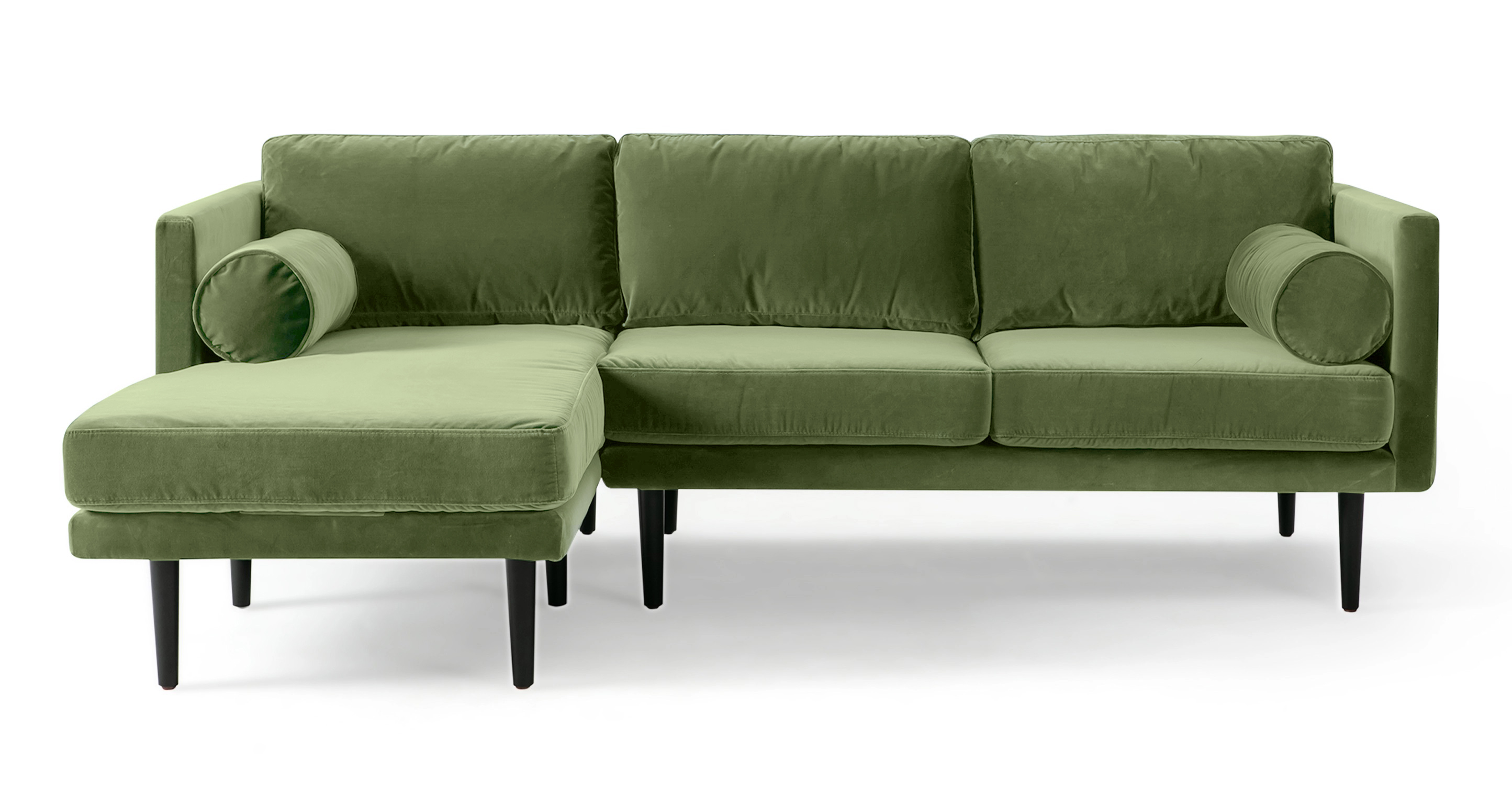 The Spectre Grass Green velvet Sectional is a timeless contemporary sofa that is 100% upholstered. It features a cohesive design with both the base frame and arms sharing the same thickness, resulting in a harmonious and consistent look. The sofa's portion has two seat and back cushions are removable and strike a balance between being well-cushioned and not overly stuffed. The chaise portion has one large seat cushion and one back cushion. To further enhance comfort, the Spectre includes two bolster pillows positioned on either side of the arm. The sofa is raised by tapered wooden legs.