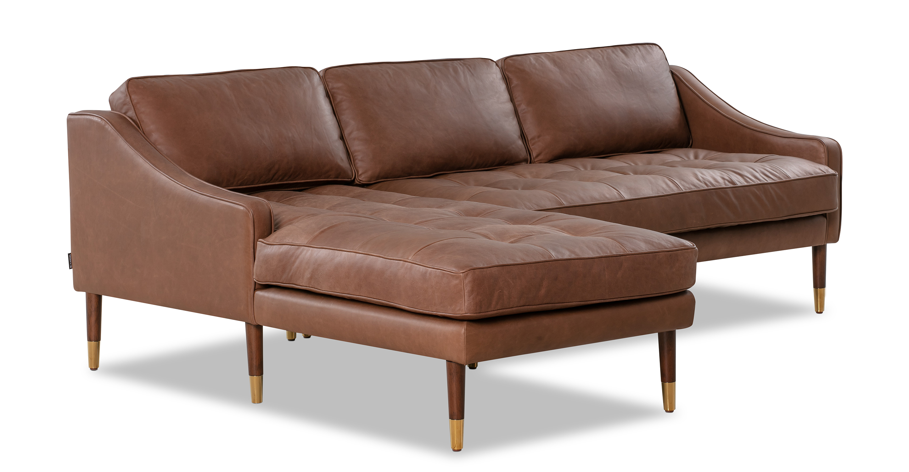 Brando is a modern sectional in brown leather. The chaise of the sectional, when you are facing the sectional, is on the left and the sofa portion is on the right. Walnut stained legs with gold tips toward the floor. The sofa fully upholstered and has swooping arms that taper from the back, down to the front. Both back and seat cushions are removable. The back cushion is smooth, the seat cushion is tufted. (facing side)