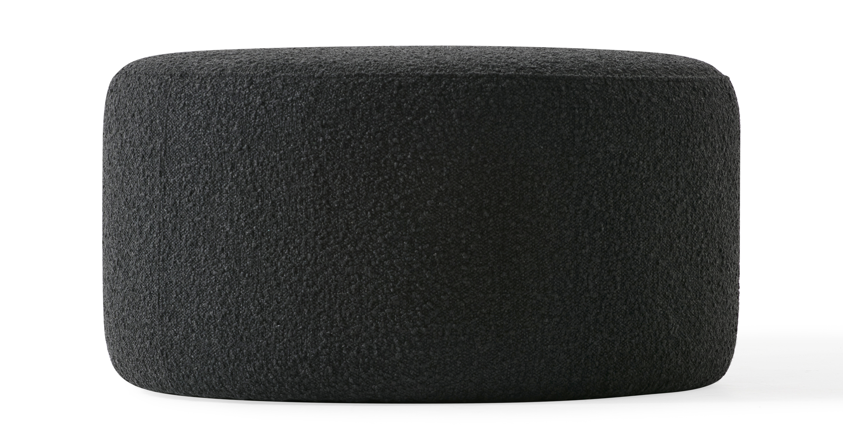 The Spool Nior Dark Grey Boucle ottoman is a 100% upholstered modern round ottoman that is more flat on top to allow it to cross over to a coffee table and seating option. There is an edge piping along the top circle. Style is simplistic, modern, and sophisticated.