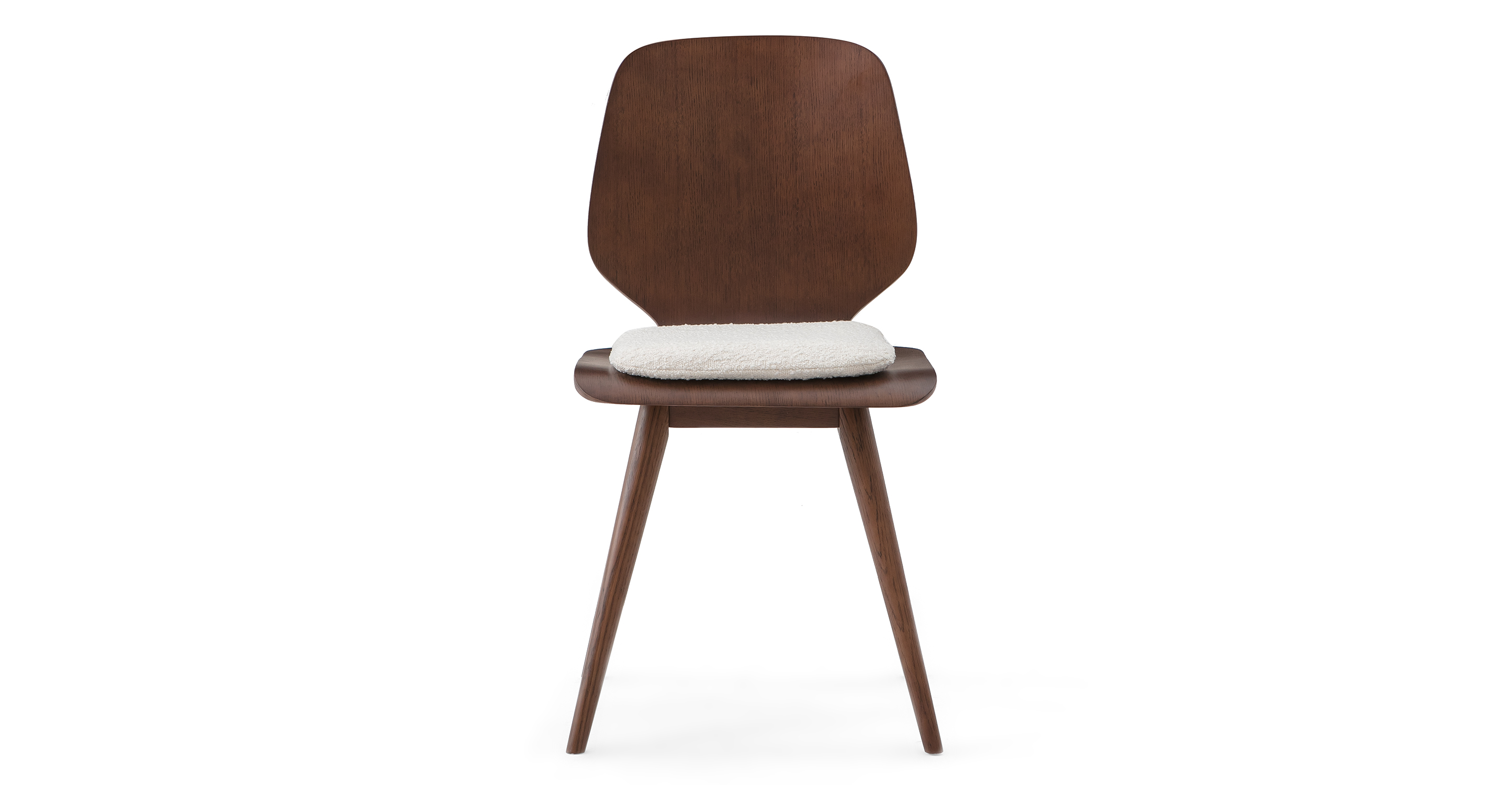 The Oslo dining chair is walnut wood with mostly solid back, rounded top edges, and lower back that tapers in as it meets the seat. The seat is curved plywood with a removable low profile cushion. The four legs are taper.