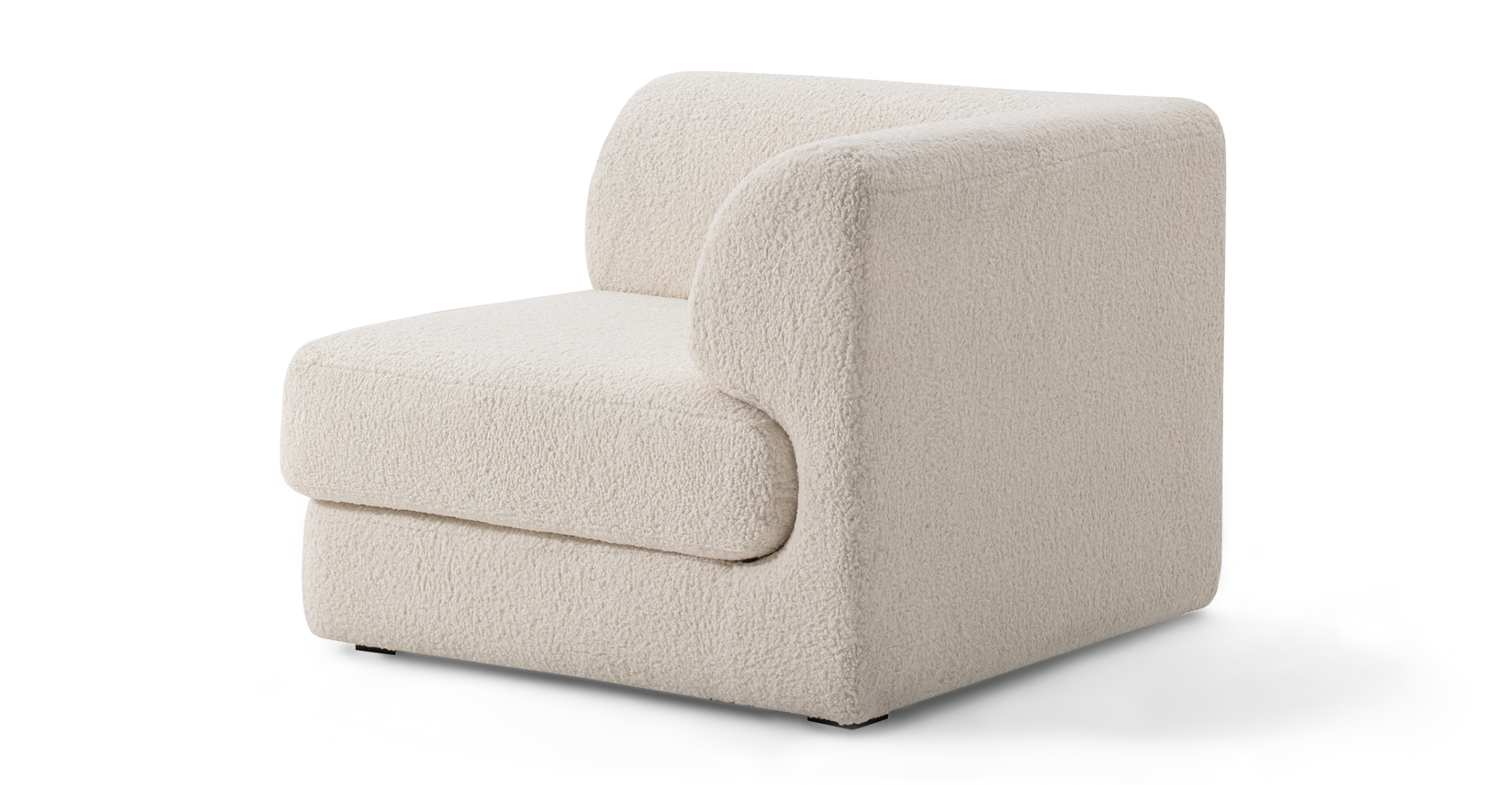 The Shelter series is a stunning and contemporary modular sofa with a sleek design, characterized by its low profile and elevated stance on slender black squared legs.
The Shelter seat cushion is curved at the back and fits into the chair back like a puzzle piece. Imaged is the Single arm or corner Shelter chair in Sheep Skin.