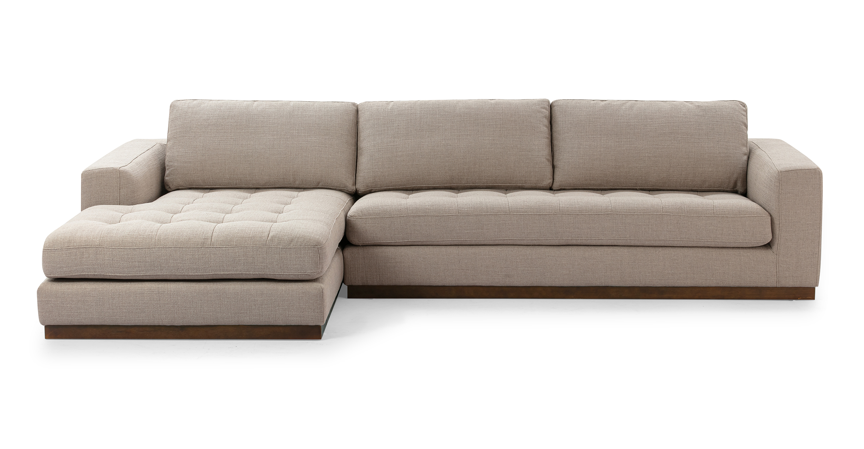 Newport floor sofa series in Dunes color offers a substantial and solid feel. The base of the sofa series is crafted from walnut wood, providing a sturdy and stylish foundation. The modular design allows for flexibility in configuring the components to suit your preferences and space.
Each component of the series features an upholstered base that is attached to the wooden frame, combining both comfort and durability. The seat and back cushions are removable, allowing for easy customization and cleaning.
The arms of the sofa pieces are rectangular, providing a clean and contemporary aesthetic.
In the Newport 4 sectional, one single arm sofa connects to a one arm chaise to provide a sofa sectional experience.