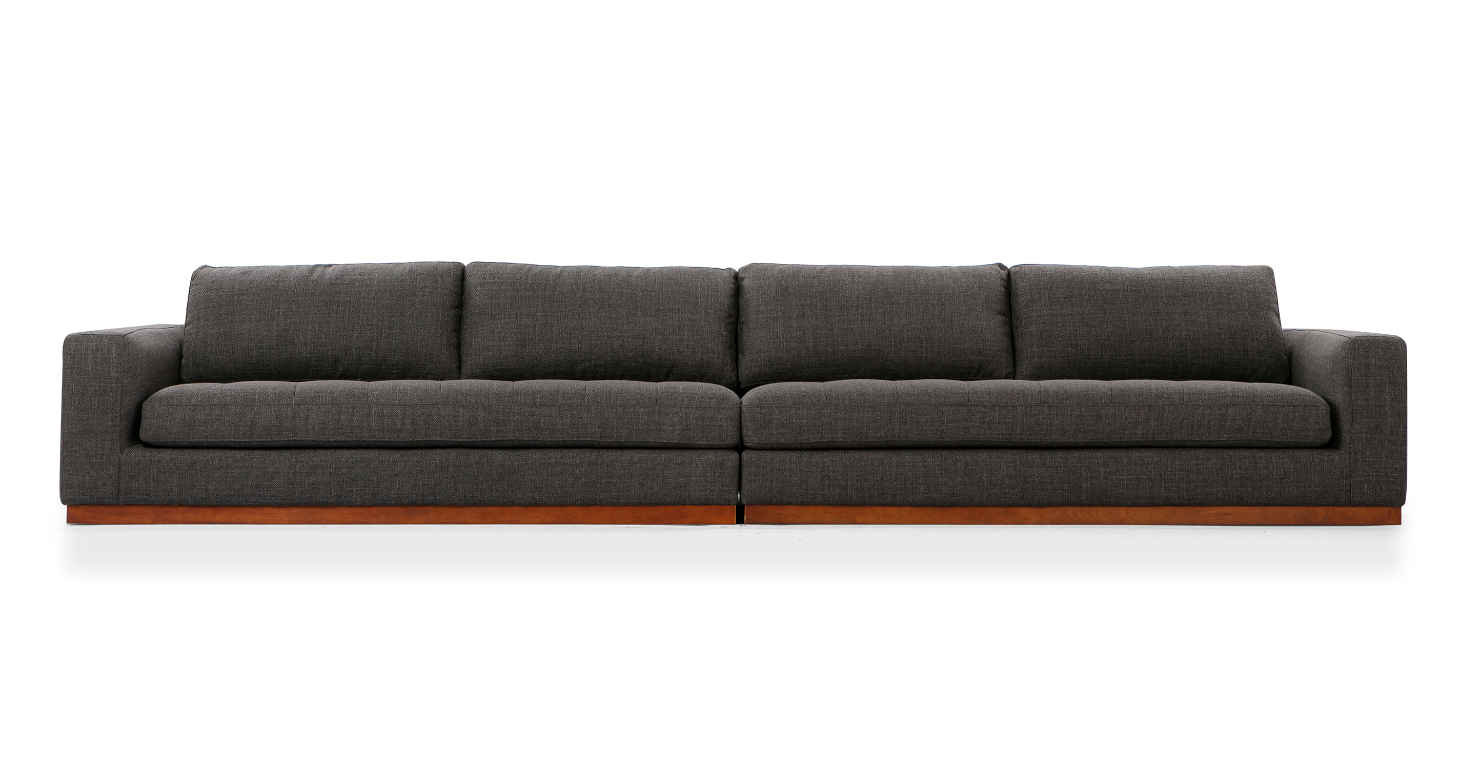The Newport Dior Grey floor sofa series offers a substantial and solid feel. The base of the sofa series is crafted from walnut wood, providing a sturdy and stylish foundation. The modular design allows for flexibility in configuring the components to suit your preferences and space.
Each component of the series features an upholstered base that is attached to the wooden frame, combining both comfort and durability. The seat and back cushions are removable, allowing for easy customization and cleaning.
The arms of the sofa pieces are rectangular, providing a clean and contemporary aesthetic.
In the Newport 4 series, two single arm sofas connect to provide a long continuous sofa experience.
