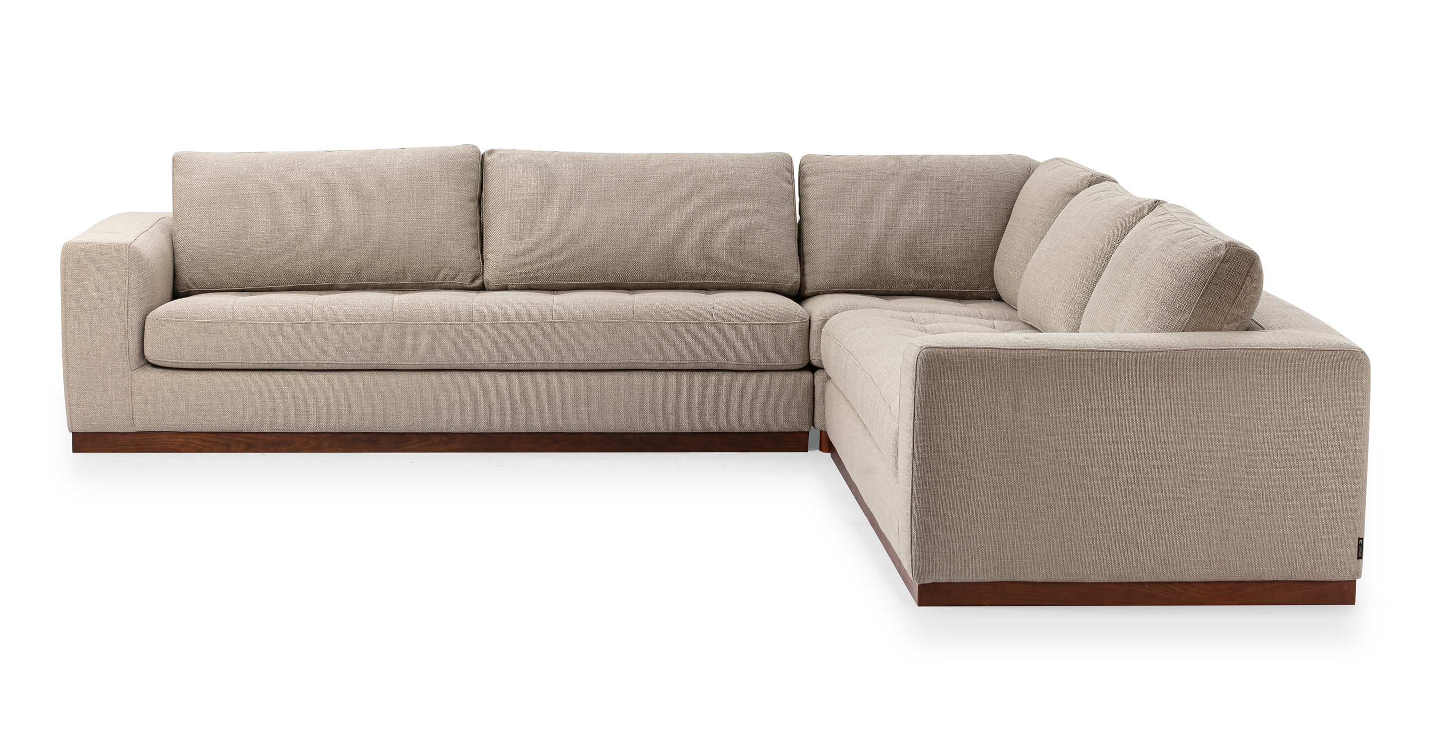 Newport floor sofa series in Dunes color offers a substantial and solid feel. The base of the sofa series is crafted from walnut wood, providing a sturdy and stylish foundation. The modular design allows for flexibility in configuring the components to suit your preferences and space.
Each component of the series features an upholstered base that is attached to the wooden frame, combining both comfort and durability. The seat and back cushions are removable, allowing for easy customization and cleaning.
The arms of the sofa pieces are rectangular, providing a clean and contemporary aesthetic.
In the Newport 5 L sectional, two single arm sofas connect to a corner piece to create an L sectional shape.
