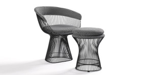 The Platner dining chairs have a wide base that tapers up and meets a bucket seat also made of black stainless steel rods. The arms and black are cushioned with upholstery and the seat has a removable cushion. 