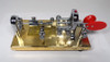 NOS Vibroplex Original Presentation gold base Morse bug, serial 105376, original Mobile AL box. Minor side corrosion from storage. Classic CW key, jeweled movement, red paddles. Ready for the collector or operator.