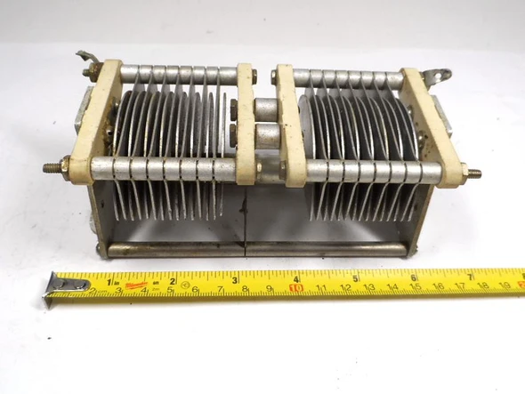 Genuine E.F. Johnson 100ED30 dual-section air variable capacitor. Each section 10-99 pF (approx. 14-105 pF measured), 0.075″ plate spacing, 2200 V peak rating. Compact Type E design with steatite insulation, aluminum plates, ¼″ shaft. Ideal for ham radio, antenna tuners, amplifiers, transmitters, and RF projects. Dimensions approx. 6⅝″ L × 2¾″ W × 2⅝″ H. Classic Waseca, MN quality. Clean used condition. Perfect for restoration or new builds needing reliable dual air variable capacitance.