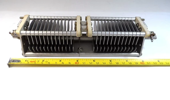 Genuine E.F. Johnson 100FD30 dual-section air variable capacitor. Each section approximately 13-99 pF (measured ~15-106 pF), 0.075″ plate spacing, 2200 V peak. Compact Type F design with steatite insulation, aluminum plates, and ¼″ shaft. Ideal for ham radio, antenna tuners, amplifiers, transmitters, and RF projects. Dimensions approx. 9″ L × 2″ W × 2″ H. Classic Waseca, MN quality. Clean used condition. Perfect for restoration or new builds needing reliable dual air-variable capacitance.
