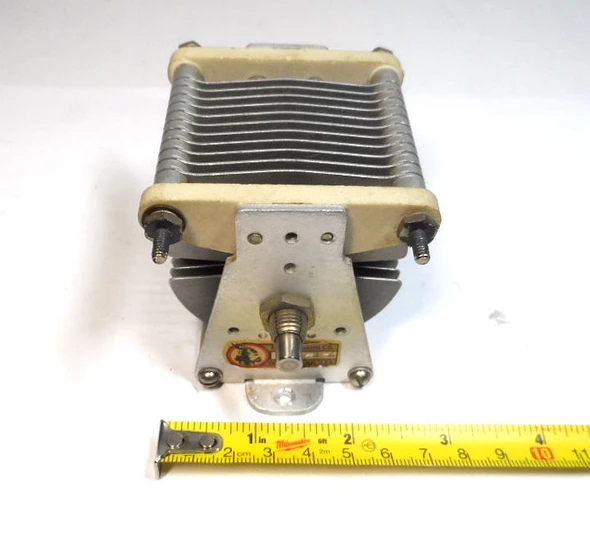 Genuine E.F. Johnson 154-1-4 single-section air variable capacitor. Capacitance approximately 15-250 pF (catalog 12-244 pF), 0.045″ plate spacing, 2000 V peak rating. Compact Type E design with steatite insulation, aluminum plates, and ¼″ shaft. Ideal for ham radio, antenna tuners, amplifiers, transmitters, and RF projects. Dimensions approx. 4″ L × 2⅝″ W × 2⅝″ H. Classic Waseca, MN quality. Clean used condition. Perfect for restoration or new builds needing reliable air-variable capacitance.