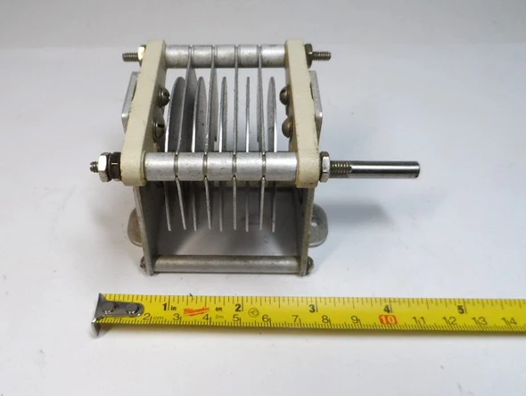 Genuine E.F. Johnson 154-11 single-section air variable capacitor, measured 11–42 pF with 0.125-inch plate spacing and 5,000-volt peak rating. Compact Type E design (approximately 4½ × 2⅝ × 2⅝ inches) with ¼-inch shaft, aluminum plates, and ceramic insulation. Ideal for amateur radio transmitters, amplifiers, antenna tuners, or vintage equipment restoration. Stamped 154-11 and 9-38. Reliable high-voltage RF performance for ham radio projects and parts inventory.