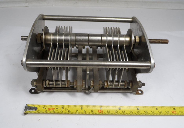 Bud dual section air variable capacitor, approximately 16-70 pF per section, estimated 4000 V rating with 3/32 inch plate spacing. Heavy-duty 7 5/8 inch long transmitting style unit with 1/4 inch shaft. Ideal for high-power RF amplifiers, antenna tuners, and ham radio projects. Quality vintage American-made Bud construction for reliable performance. Available from Nationwide Radio & Eq. Sales.