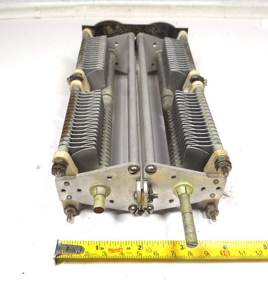 E.F. Johnson ganged air variable capacitor assembly. Consisting of two premium dual-section capacitors precision-synchronized via dual meshed brass gears, this unique configuration allows smooth 0 to 100% full-mesh rotation with a single 1/4-inch drive shaft. When wired together, the sections provide an expansive combined capacitance range from 57 pF minimum up to 830 pF maximum. Designed with an industrial-grade 1/16-inch plate spacing, it delivers a reliable 3,000V to 3,500V (3.5 kV) peak voltage rating. Measuring 9.5" L x 2" W x 4" H, this high-voltage tuning unit features rugged ceramic standoff insulators and a rigid frame, making it the perfect upgrade or replacement component for high-power linear amplifiers, broadcast transmitters, and custom antenna tuners.