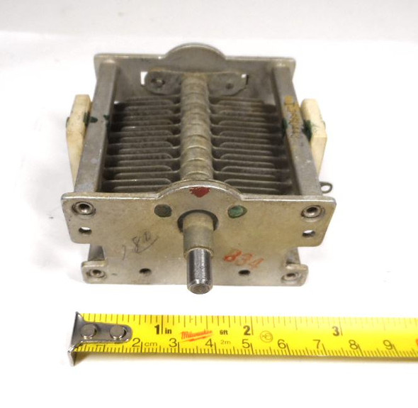 Military surplus G.E. T7660443-7 single-section air variable capacitor, 20–86 pF, approximately 1500 V peak rating. Classic USA-made multi-plate design with ceramic insulators, 1/4-inch shaft, and ~1/32-inch plate spacing. Ideal for amateur radio transmitters, receivers, antenna tuners, or restoration projects. Measures about 3-3/4 × 3-1/4 × 2-1/4 inches. Solid condition for surplus gear—perfect for ham radio builders needing reliable RF tuning components.