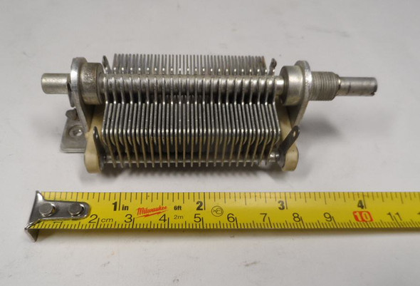 EF Johnson Single-section air variable capacitor model 962, 15–305 pF, approximately 1000 V peak rating. Compact multi-plate design with ceramic insulators, ~1/64-inch plate spacing, and 1/4-inch shaft. Measures about 4-1/4 × 1-3/4 × 1-3/4 inches. Ideal for amateur radio receivers, restoration projects, or RF tuning applications needing a reliable high-capacitance component in a small frame.