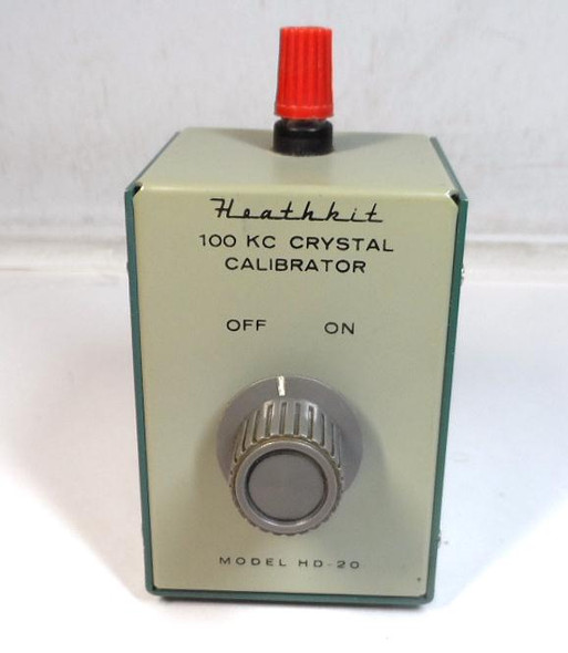 Heathkit HD-20 100 kHz Crystal Calibrator in excellent cosmetic  condition. Provides strong 100 kc markers and harmonics from 100 kHz up to 54 MHz+ for precise dial calibration, band edge checking, and receiver alignment. Simple one-transistor design runs on 9V battery with adjustable output and fine frequency trimmer (easily zero-beats to WWV). Compact vintage Heathkit accessory ideal for any analog-tuned ham receiver, SWL rig, or vintage transceiver. Perfect addition to complete a classic Heathkit station or restore accurate frequency readout on older gear