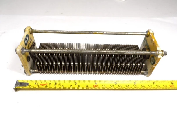 Find premium vintage radio gear with this authentic General Electric single-section air variable capacitor. Built with a robust 1/32-inch plate spacing, this high-voltage tuning unit delivers a stable 26 to 480 pF capacitance range rated for 1.2kV to 1.5kV applications. Featuring ceramic end insulators with the classic GE logo, an 8-inch body length, and a standard 1/4-inch diameter shaft, it is perfectly suited for linear amplifiers, antenna tuners, and ham radio repair. We have three identical industrial-grade units available, including model variations X-112, C-141, and P-7763513-1 (one featuring an RC Company contract stamp). Upgrade or restore your RF equipment today with reliable, heavy-duty components from our nationwide inventory.