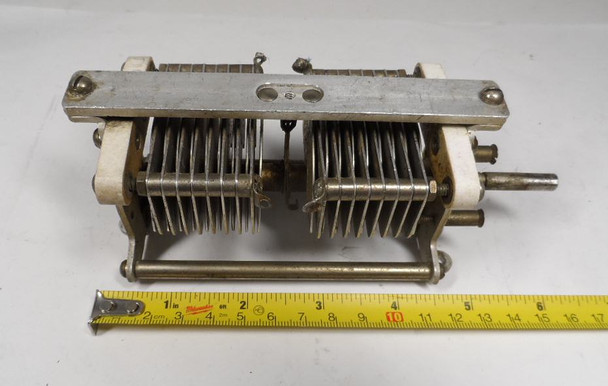 National dual-section air variable capacitor marked 100. Approximately 8–120 pF per section at 3000 V peak with ~1/16″ plate spacing. Classic USA-made National Radio transmitting-style unit with 1/4″ shaft, ideal for HF amplifiers, balanced circuits, antenna tuners, or vintage radio restoration. Measures about 6″ long. Excellent condition for age. Perfect for ham radio builders seeking authentic National dual-section capacitors.