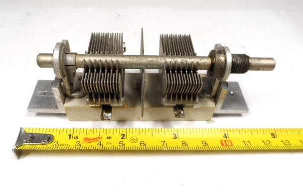Dual-section air variable capacitor, 7–105 pF per section, approximately 1000 V peak rating. Compact multi-plate design with ~1/64-inch plate spacing and 1/4-inch shaft. Measures about 4-3/4 × 1-5/8 × 2-1/4 inches. Ideal for amateur radio receivers, restoration projects, or RF tuning applications needing matched ganged sections for simultaneous tuning.