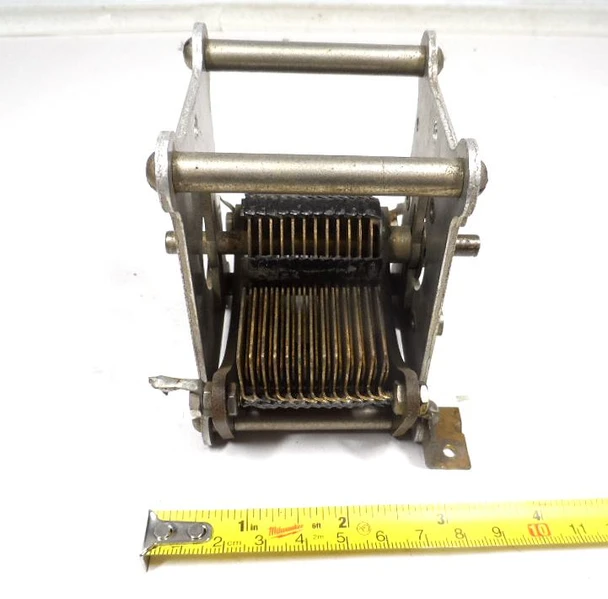 Unmarked single-section brass-plate air variable capacitor, 23–562 pF, approximately 1000 V peak rating. Compact multi-plate design with ~1/64-inch plate spacing and 1/4-inch shaft. Measures about 3-1/2 × 3-1/2 × 3-7/8 inches. Ideal for amateur radio receivers, restoration projects, or RF tuning applications needing a high-capacitance low-voltage component.