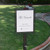Decorative Slip Over Sign Holder installed in a garden bed along a walk way