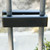Between the balusters Wrought Iron Fence Sign Holder