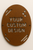 Corten Steel oval sign bolted on a white wall - custom design 