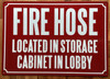 FIRE HOSE LOCATED IN STORAGE CABINET IN LOBBY SIGN