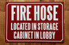 FIRE HOSE LOCATED IN STORAGE CABINET IN LOBBY COMPLIANCE SIGN