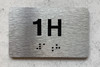 APT# 1H Braille Sign
