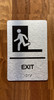 Exit Left With Symbol With Sign with Raised Letters Ada Sign