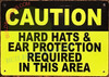 Sign CAUTION HARD HATS AND EAR PROTECTION REQUIRED IN THIS AREA