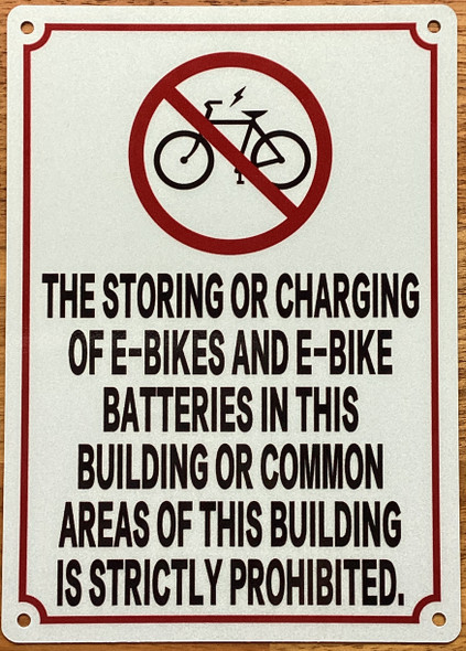 the-storing-or-charging-of-e-bikes-and-e-bikes-batteries-sign-5-x-7-inches-white-aluminum-sign.jpg