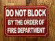 DO NOT BLOCK BY ORDER OF FIRE MARSHAL COMPLIANCE SIGN