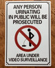ANY PERSON URINATING IN PUBLIC WILL BE PROSECUTED -NO PUBLIC URINATION COMPLIANCE SIGN