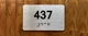Apartment number 437 Ada Sign
