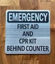 silver-emergency-first-aid-cpr-kit-behing-counter-building-notice.jpg