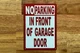 no-parking-in-front-of-garage-door-5x7-building-signage.jpg