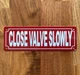 2x6-close-valve-slowly-metal-identification-sign.jpg