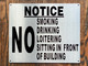 NO SMOKING DRINKING LOITERING SITTING IN FRONT OF BUILDING SIGN