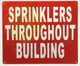 The "Sprinklers Throughout Building" sign is an important safety measure that serves as a reminder to building occupants of the presence of a fire suppression system. This sign, typically displayed near exits and in prominent areas of the building, alerts people of the potential for a sprinkler system to activate in the event of a fire.

The presence of a "Sprinklers Throughout Building" sign has multiple benefits. Firstly, it increases awareness of the fire protection system, which can help to calm occupants in the event of a fire. Secondly, it reinforces the importance of fire safety and the role of sprinkler systems in controlling fires. Additionally, the sign serves as a deterrent for would-be arsonists, who are less likely to start a fire in a building that is equipped with a sprinkler system.

In addition to its informational function, the "Sprinklers Throughout Building" sign is also a requirement of many fire codes and building regulations. The sign must meet specific size and placement requirements and must be easily visible from a distance. The sign must also be updated as necessary to reflect changes to the fire suppression system, such as upgrades or maintenance work.

In conclusion, the "Sprinklers Throughout Building" sign is a crucial component of fire safety in buildings. Its presence alerts occupants to the presence of a fire suppression system, reinforces the importance of fire safety, and serves as a deterrent to arsonists. Building owners and managers should ensure that the sign is properly displayed and maintained, and that building occupants are aware of its significance.