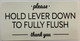 PLEASE HOLD LEVER DOWN TO FULLY FLUSH STICKER