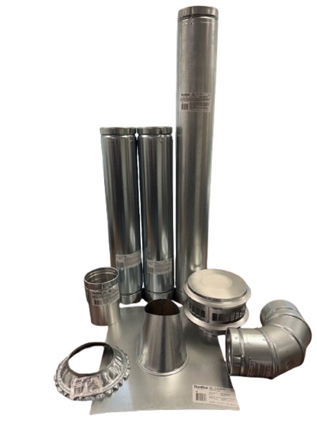 The image shows a 4" Vertical Unit Heater Vent Kit, consisting of multiple metal components designed for venting unit heaters. The kit includes straight vent pipes, elbow connectors, a vent cap, flashing for sealing around roof openings, and other connectors. These pieces are typically made from durable galvanized steel or similar materials and are intended to create a proper exhaust path for heaters. Based on the context from Total Home Supply, this is part of a vertical venting system for heaters like those in the Reznor UDX series.