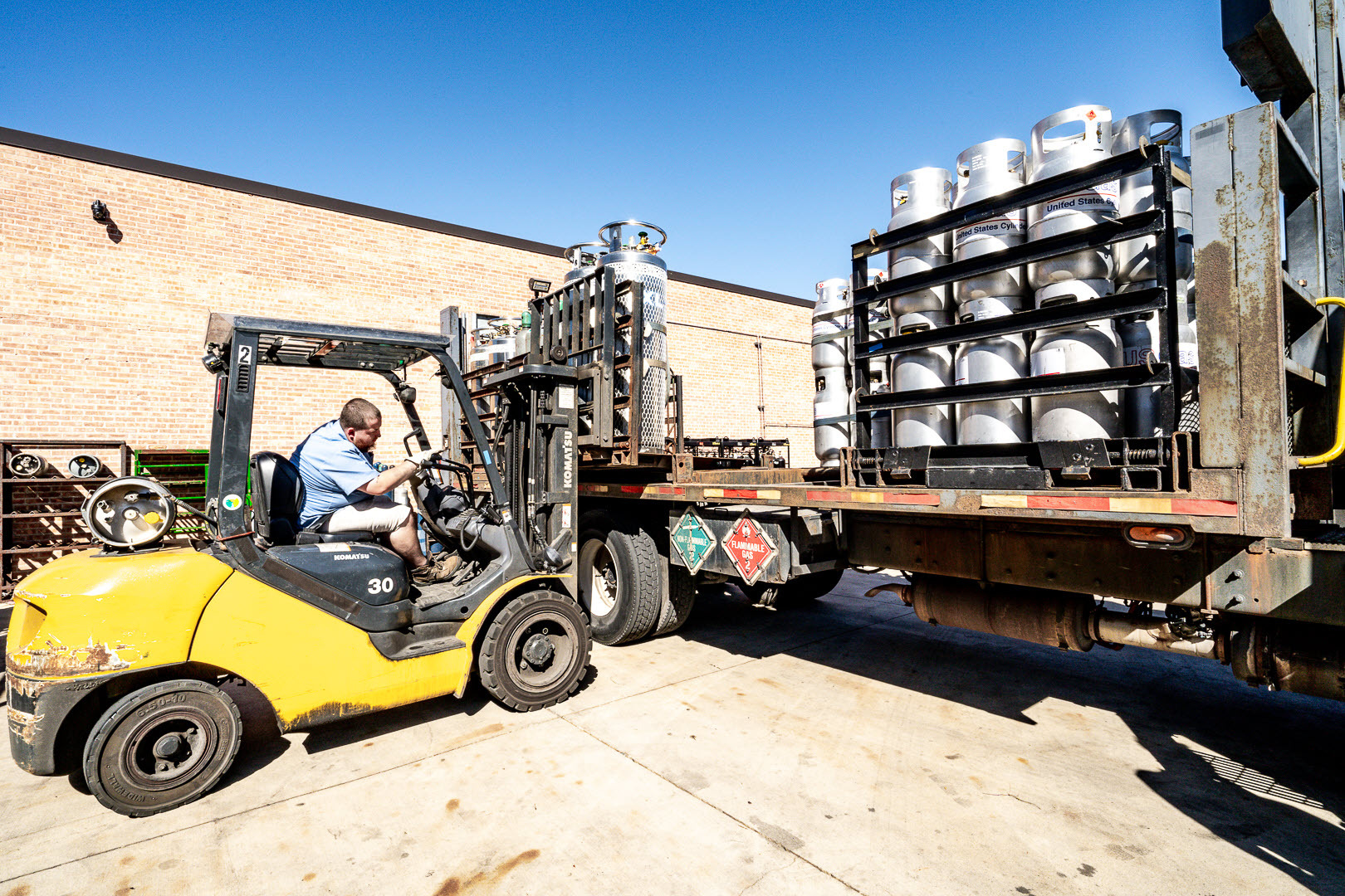 man loading truck with gas cylinders