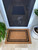 Coir Mat at single front door with black double border styled with plants and cavoodle