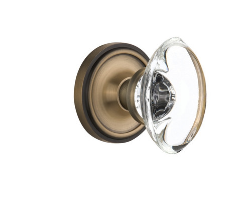 Nostalgic Warehouse - Classic Rosette Privacy Oval Clear Crystal Glass Door Knob in Antique Brass - CLAOCC - 711608 - 2 3/8" Backset
