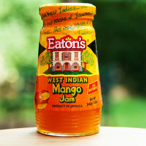 Enjoy the tropical sweetness of Eaton's Mango Jam! Made with the delicious flavor of ripe, juicy mangoes, this smooth and fruity jam is perfect for spreading on toast, bagels, biscuits, and pastries. It also makes a delightful addition to desserts, yogurt, and baking recipes. Bring the taste of the Caribbean to your breakfast and snacks with every spoonful of Eaton's Mango Jam.