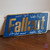 Fallout signed plaque featuring autographs from Ella Purnell, Aaron Moten, Walton Goggins, and Kyle MacLachlan. Flat brushed-brass style collectible inspired by the Fallout series.