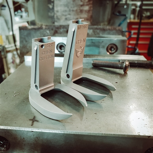 A stainless steel compact Chen SI Magwell next to a full size stainless steel Chen SI Magwell. A stainless steel compact Chen SI Magwell next to a full size stainless steel Chen SI Magwell.