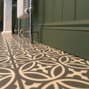 Skirting World 330 MDF Skirting Board, close-up view of green skirting board installed at the bottom of a wall with patterned floor tiles.